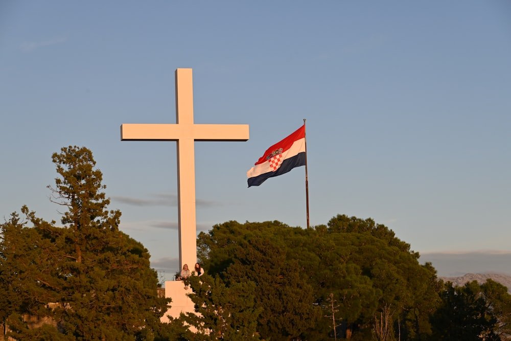 A cross and an American flag flying together